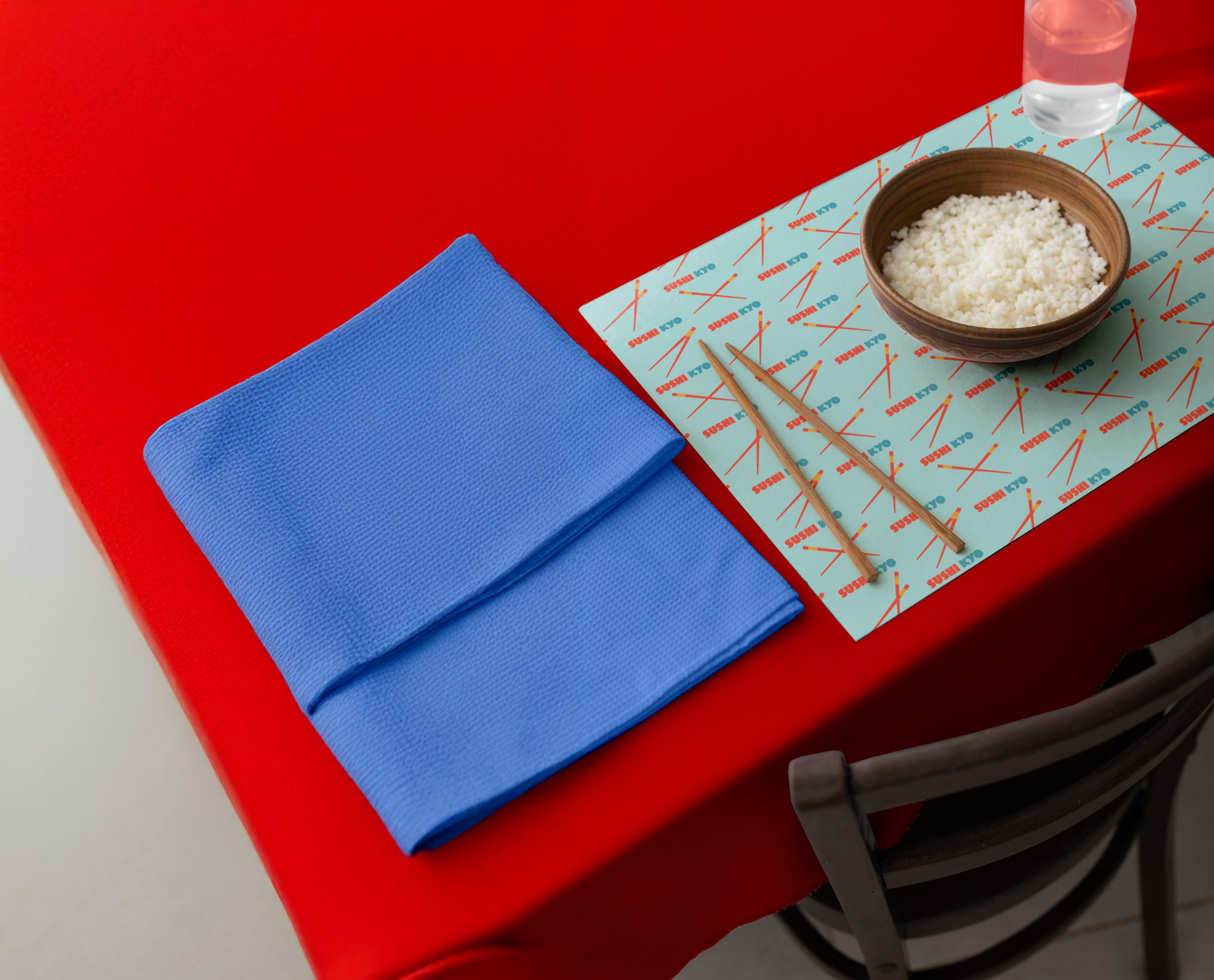 Sushi restaurant table styling with branded placemat and graphic patterns