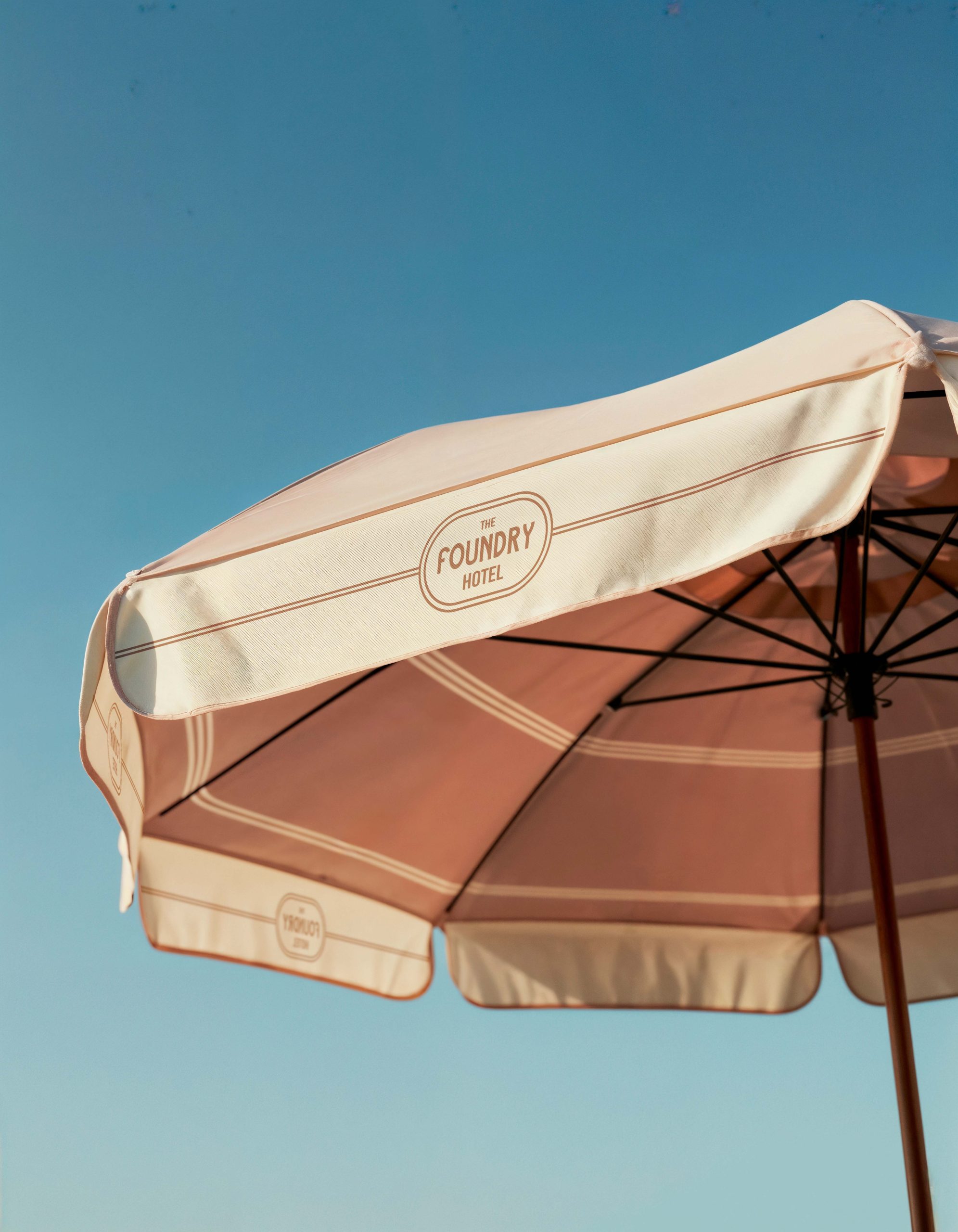 Branded hotel umbrella featuring The Foundry Hotel logo