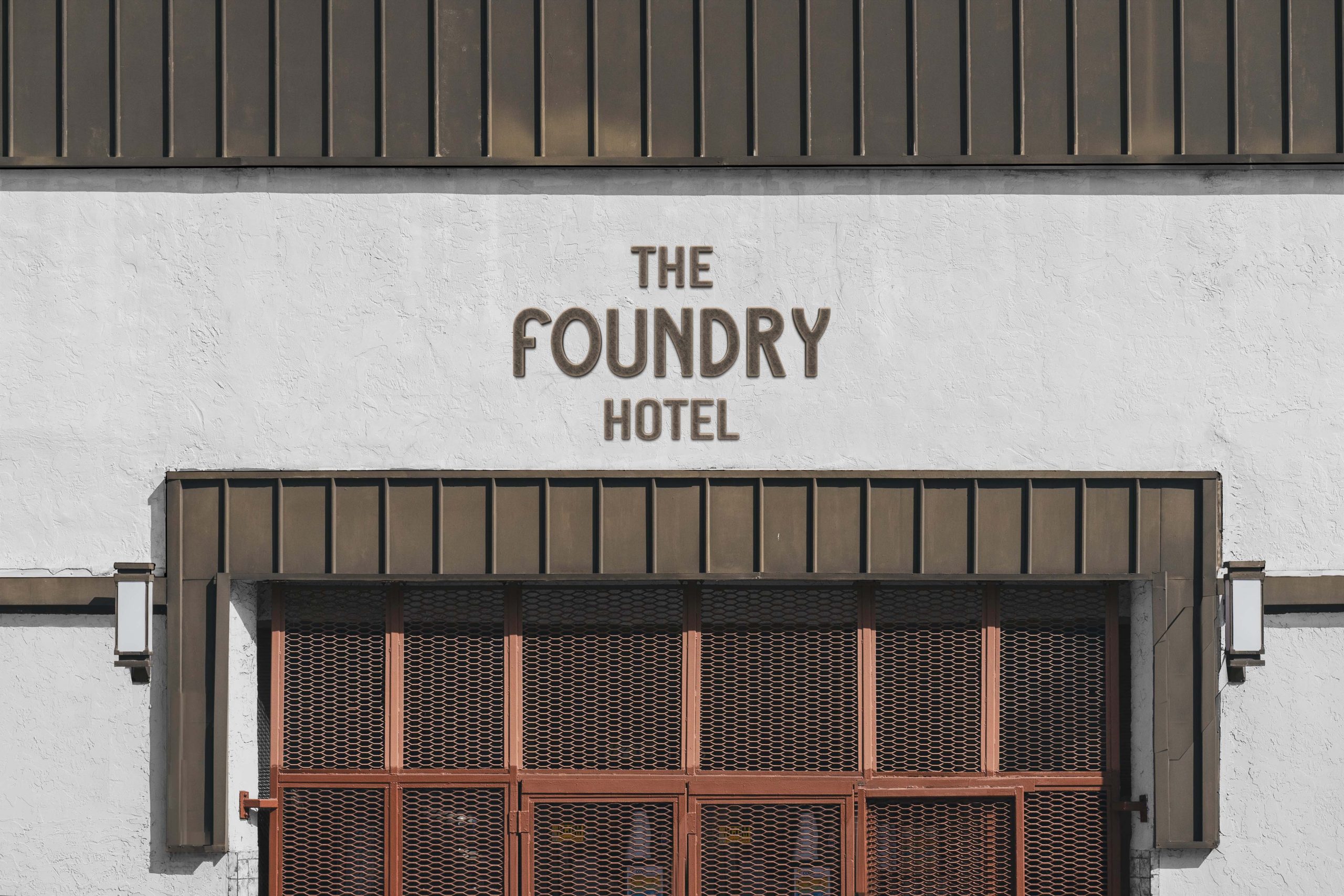 Exterior facade signage displaying The Foundry Hotel logo