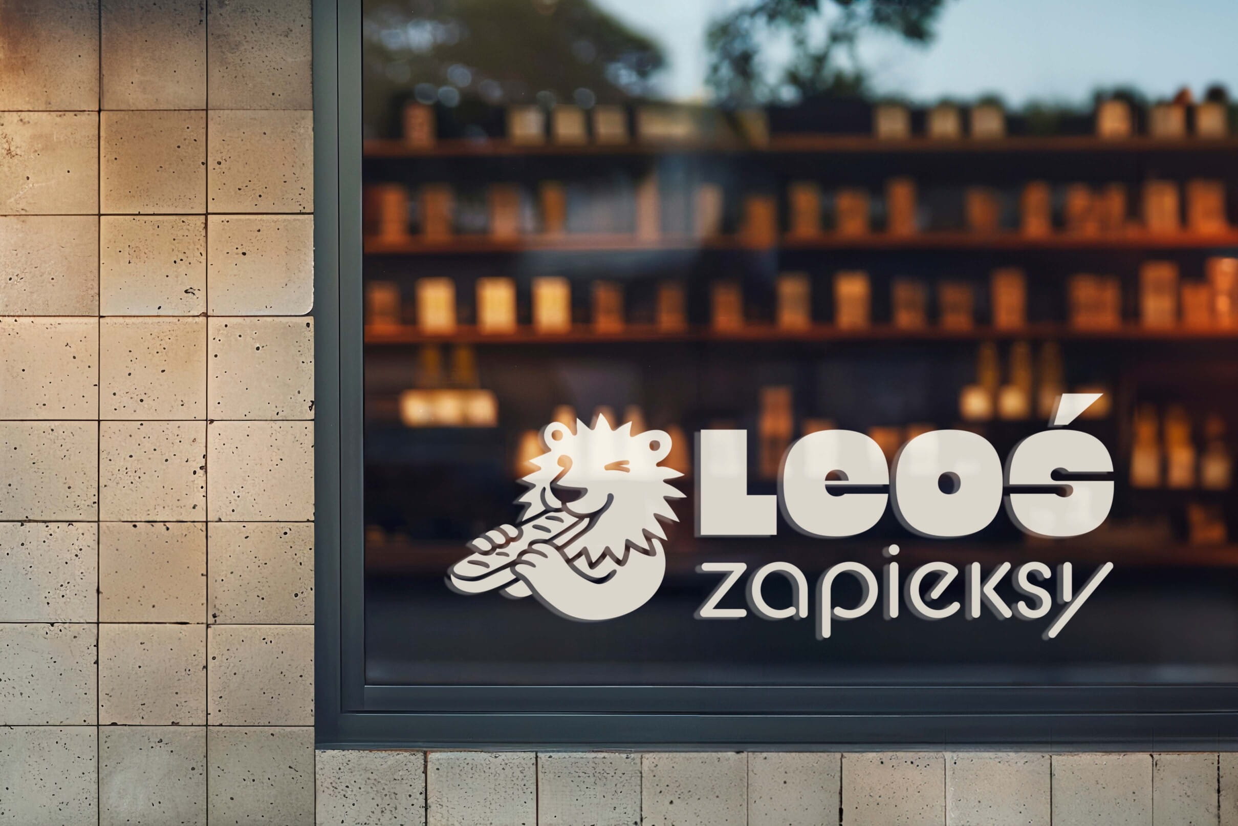 Leos Zapieksy restaurant window with illuminated logo and lion mascot
